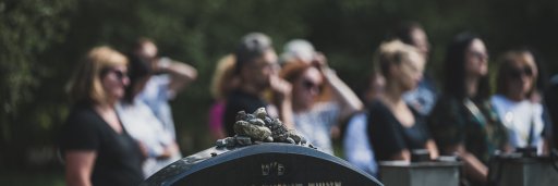 Group of women standing near the tombstone of a Jewish educator and activist Sarah Schenirer