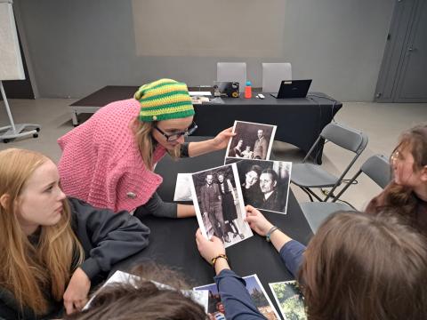 Educator showing archival pictures to school students