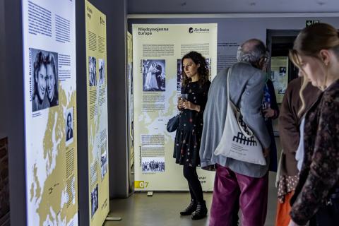 Gallery at the museum. A group of people visiting the exhibition. 