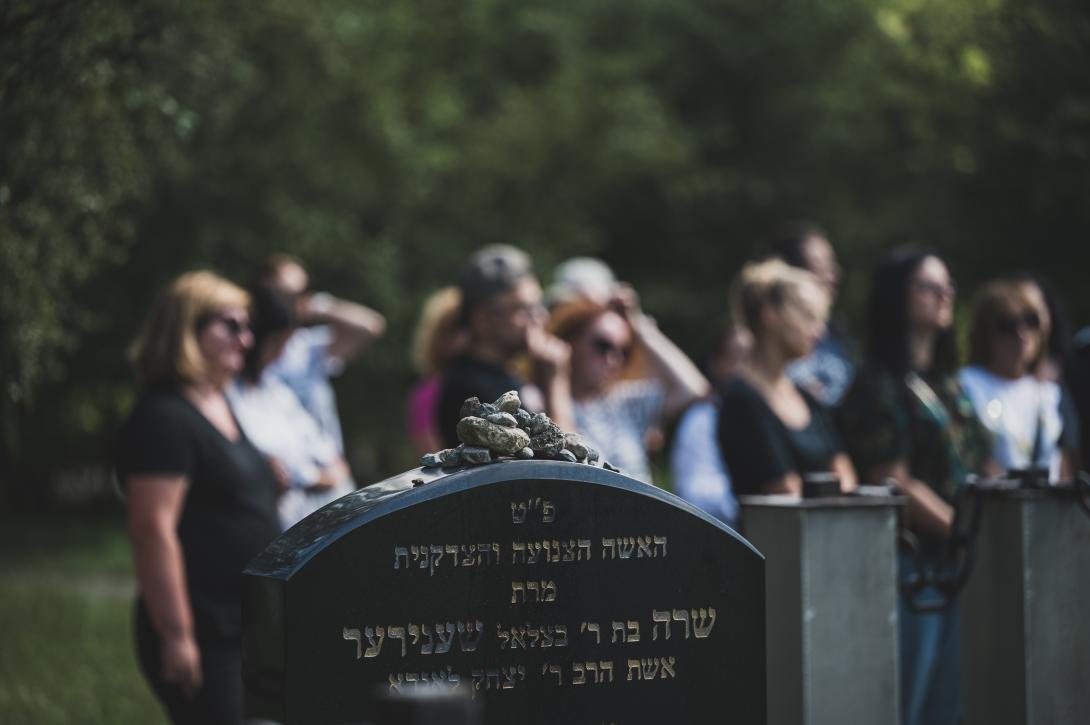 Group of women standing near the tombstone of a Jewish educator and activist Sarah Schenirer